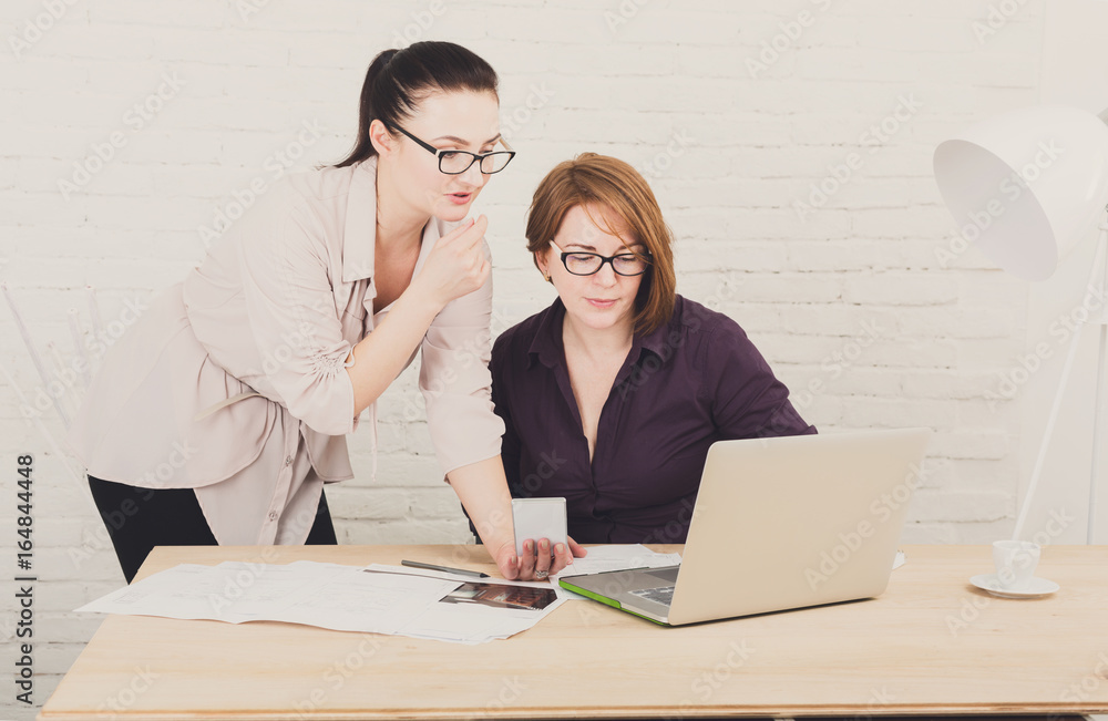 Teamwork. Women discuss project in office Teamwork. Women discuss project in office