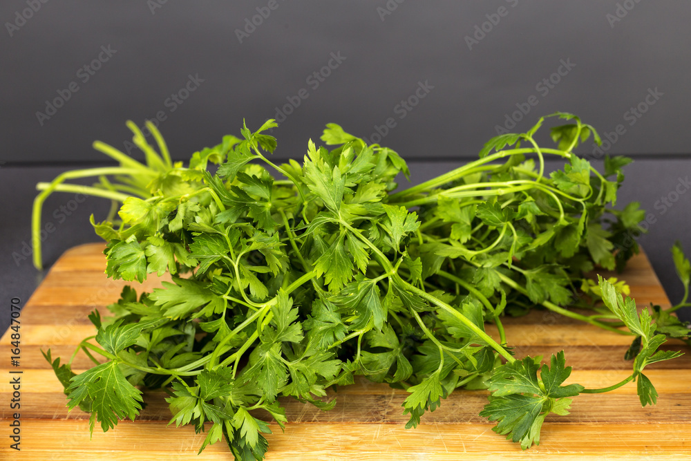 Fresh parsley on wooden cutting board Fresh parsley on wooden cutting board