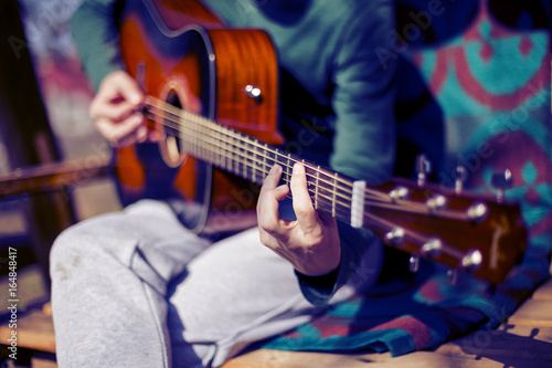 Closeup of man playing an acoustic guitar