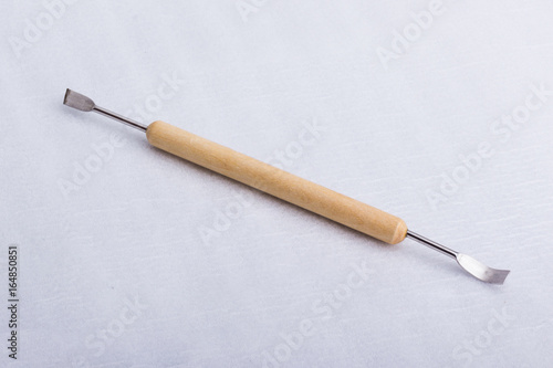 A sculpting tool on a white surface