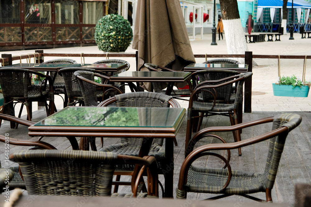 Chairs and tables on summer terrace on outdoor cafe