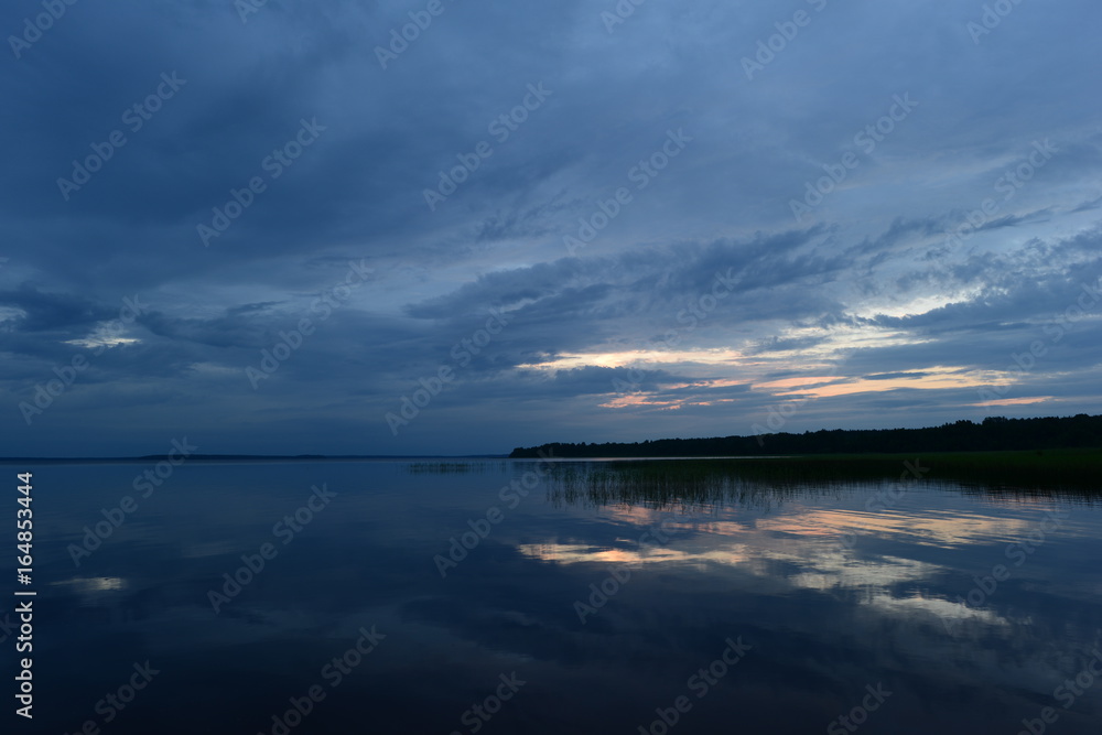 Sunset blue reflection on the lake water surface