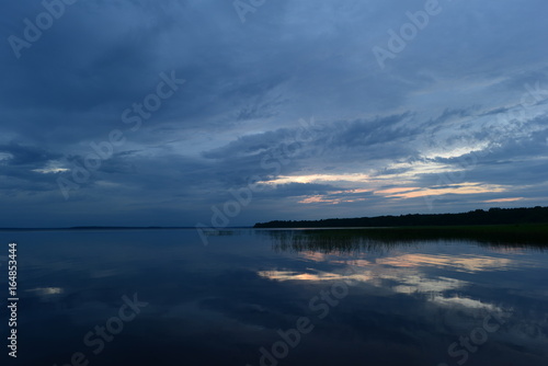 Sunset blue reflection on the lake water surface