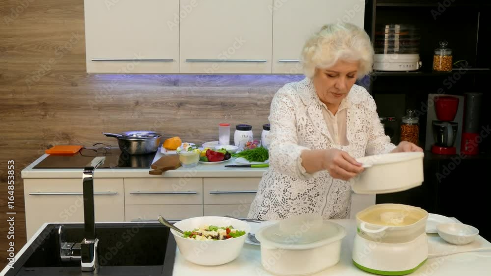 Happy Senior Woman Cooking Dinner For Big Family Happy Senior Woman Cooking Dinner For Big Family