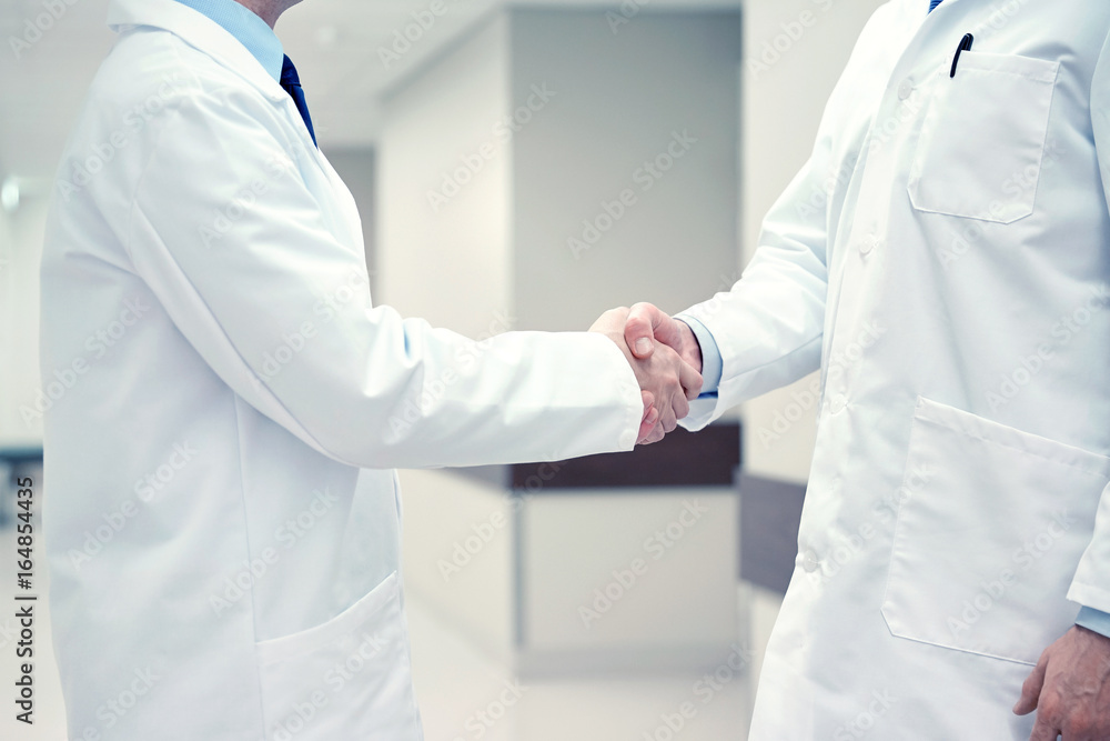 close up of doctors making handshake close up of doctors making handshake