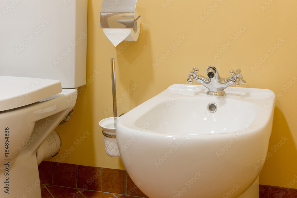 Fototapeta premium White ceramic bidet in modern bathroom.
