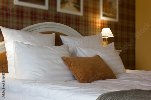 Pillows on bed in hotel roo...