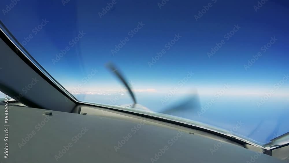 A private plane flies - a view from the cockpit - spinning propeller A private plane flies - a view from the cockpit - spinning propeller