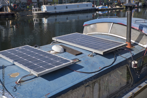 Barges with solar panels on the canal by the Olympic Park in the east End of London, UK photo