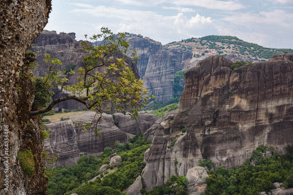 Naklejka premium Beautiful scenic view, of the mountains, monasteries and large tree on a rock of Meteora in summer, UNESCO World Heritage Site, Trikala, Greece 