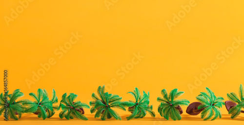 Tropical theme with little palm trees on a yellow background