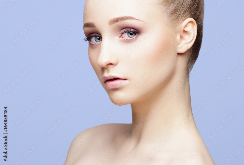 Beauty close-up portrait of beautiful, fresh and healthy girl over blue background. Beauty close-up portrait of beautiful, fresh and healthy girl over blue background.
