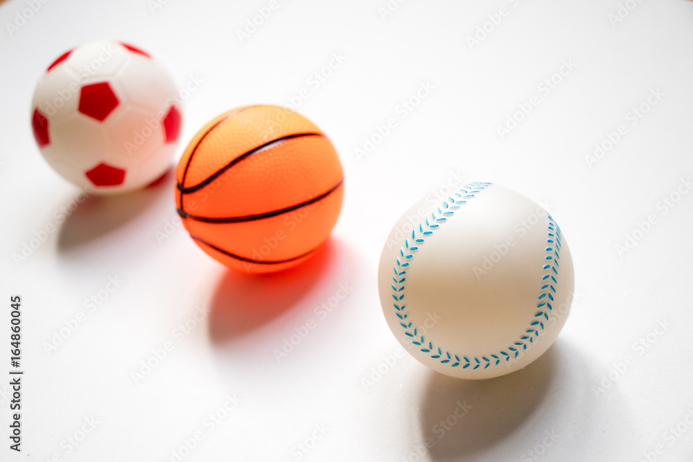 Group of football, baseball and basketball placed on white background Group of football, baseball and basketball placed on white background