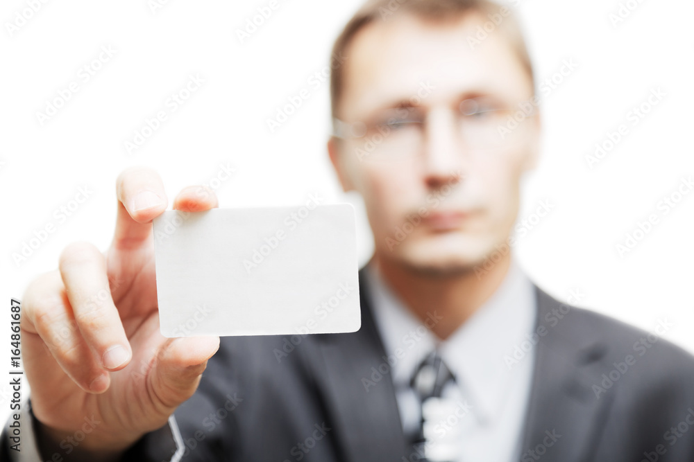 Man shows empty business card or credit card in outstretched arm. Isolated on white. Shallow focus. Man shows empty business card or credit card in outstretched arm. Isolated on white. Shallow focus.