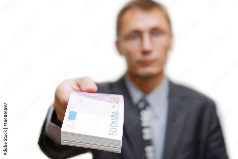 The man gives out a bundle of notes 500 euros. Shallow focus. Isolated on white. The man gives out a bundle of notes 500 euros. Shallow focus. Isolated on white.