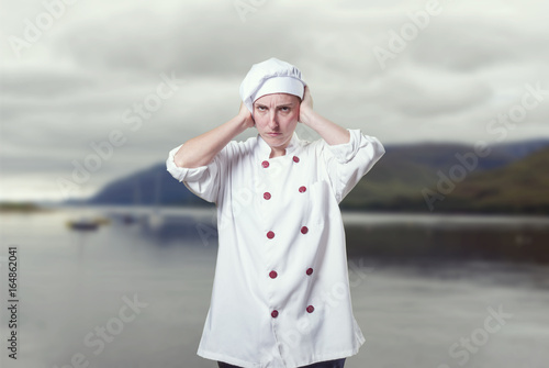 Young woman chef covering her ears with her hands © sunlight19