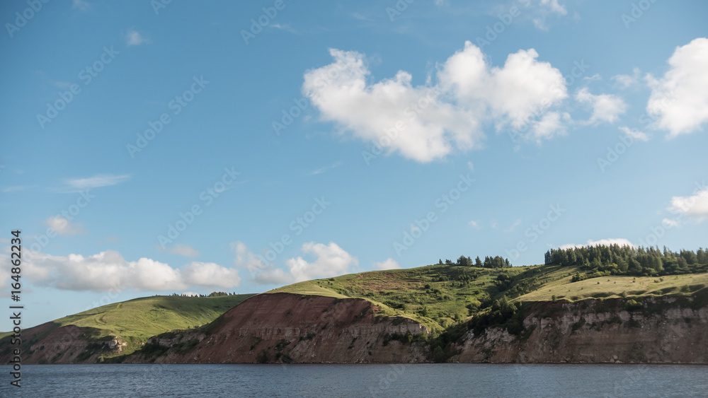 Summer landscape - european river, blue sky and green meadow on coast Summer landscape - european river, blue sky and green meadow on coast