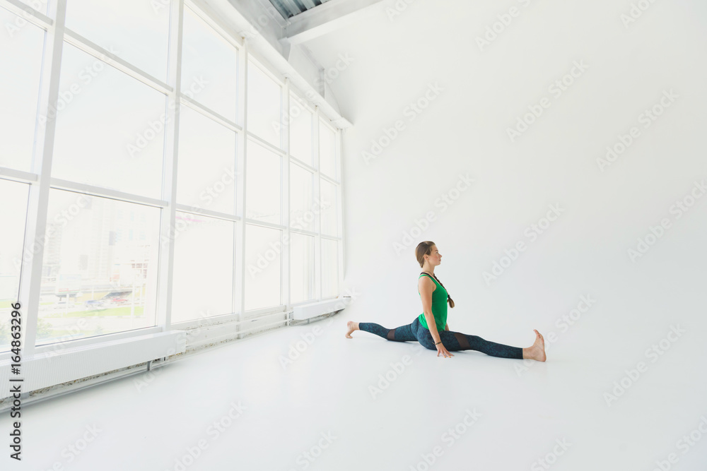 Beautiful yoga woman practice in a big window hall background. Yoga concept. Beautiful yoga woman practice in a big window hall background. Yoga concept.