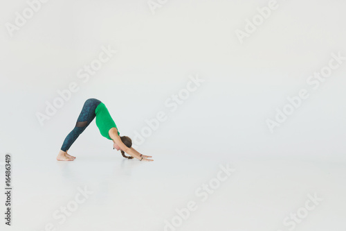 Young attractive woman practicing yoga. Young beautiful woman practicing yoga and gymnastic. Wellness concept. Classes in single sports.