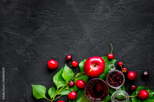 Cranberry, apple, pulm and cherry for summer fruit drink on black stone table top view copyspace