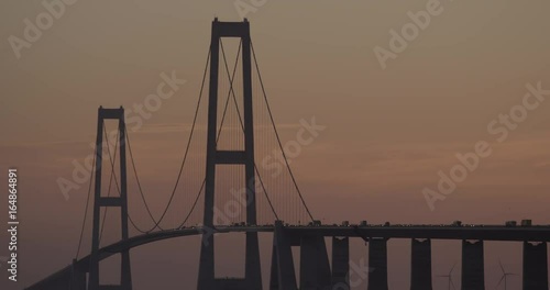 Slow motion, cars drive over Yi Sun-Sin bridge at sunset