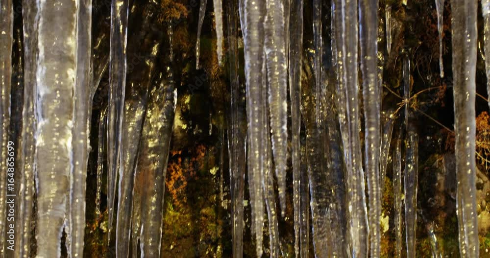 Close up, large icicles hang in cave Close up, large icicles hang in cave