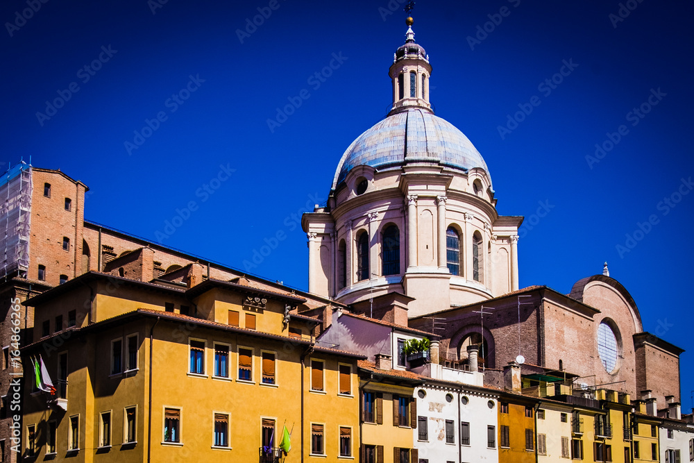 Colourful Mantua cathedral dome and houses Italy