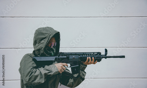 Canvastavla Gunner terrorists half face and eyes contact with masked and machine gun or rifles sniper shooting are his weapon in Ambush