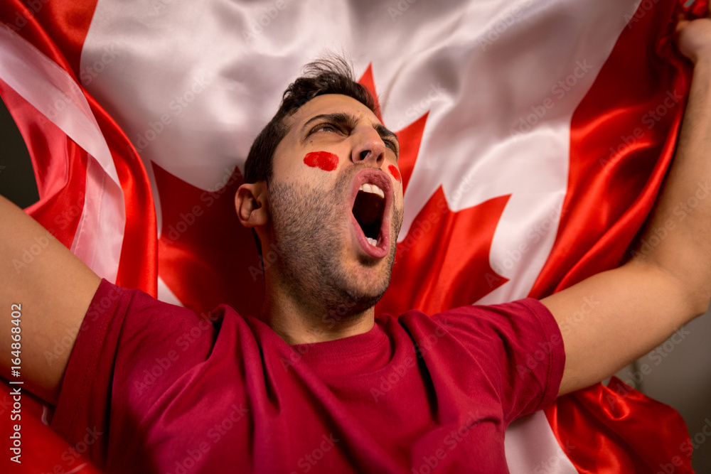 Fototapeta premium Canadian Guy Waving Canada Flag
