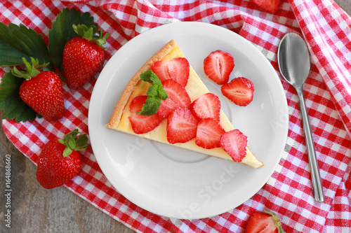 Piece of homemade cake with strawberries on plate