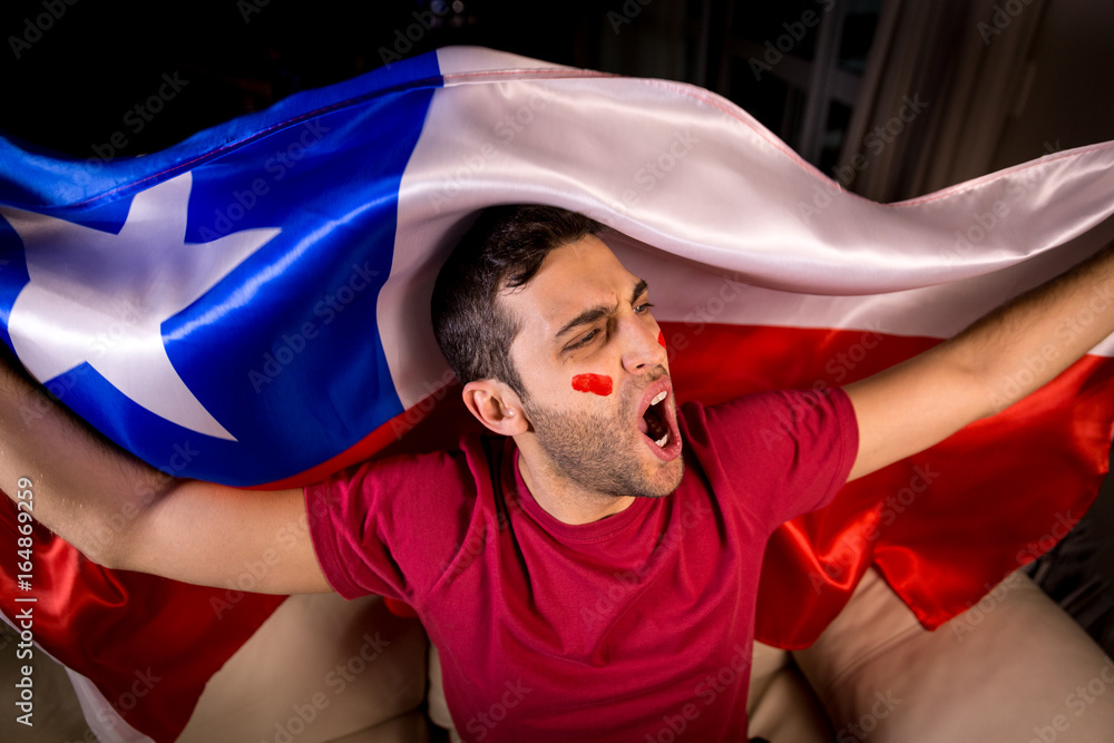 Naklejka premium Chilean Guy Celebrating with Chile Flag