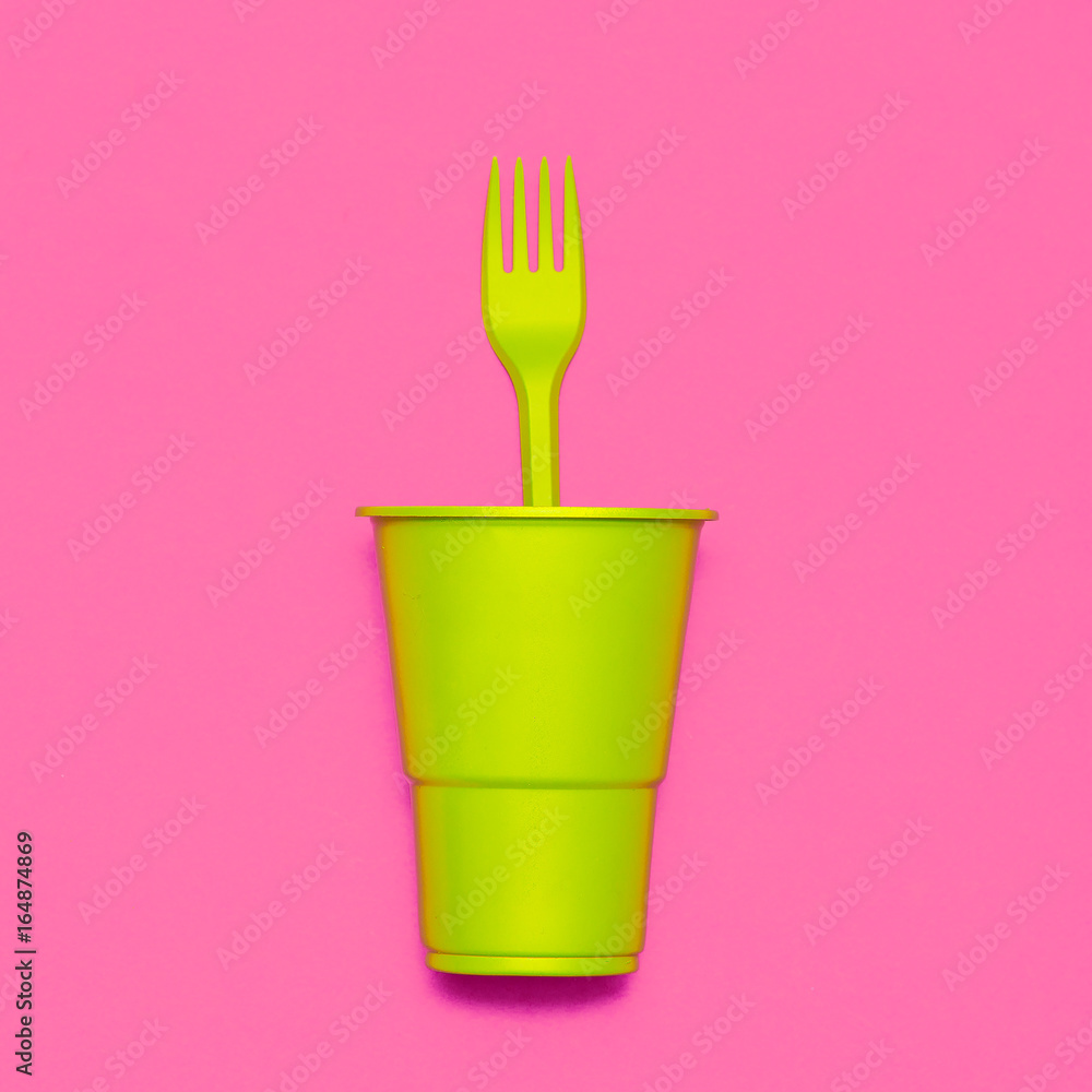Plastic tableware. Minimal. Plastic cup and fork Plastic tableware. Minimal. Plastic cup and fork