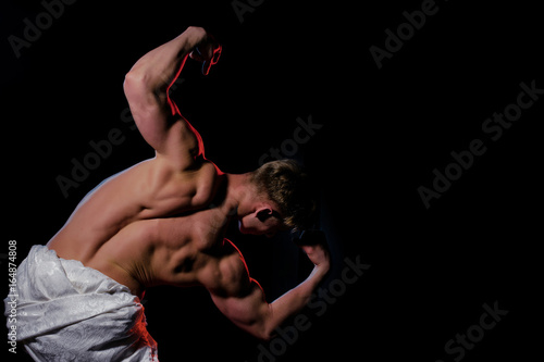 Man with muscular body in white fascia. photo