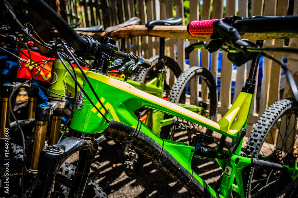 Colourful Mountain Bikes on a rack in the sunshine in Italy