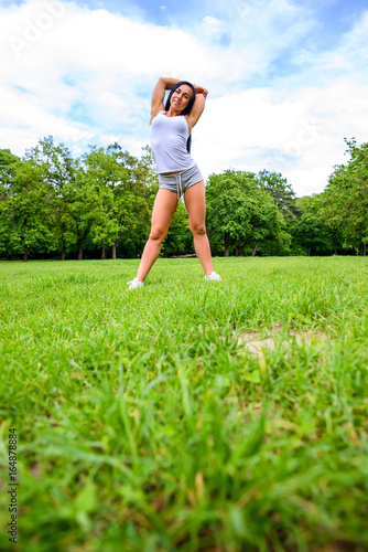 Beautiful young sporty girl in a park 