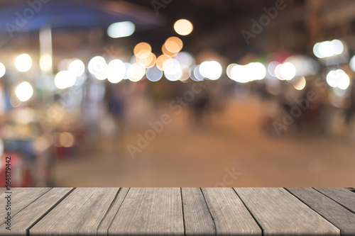 Blurred walking street with circle of bokeh and vintage wooden on font. mock up