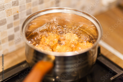 eggs boiling in the water on the gas stove
