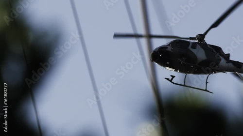 Low angle, helicopter flies across sky
