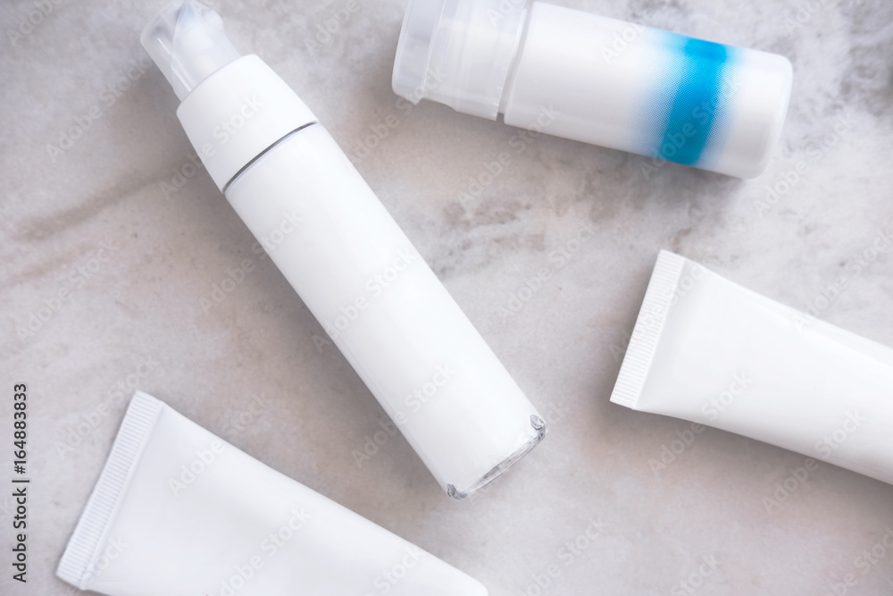 Skincare cosmetic products from above on white marble table. Cream, cleancer, moisturizer, lotion. Branding mock up. Skincare cosmetic products from above on white marble table. Cream, cleancer, moisturizer, lotion. Branding mock up.