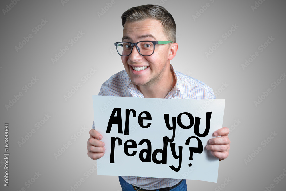 Funny laughing guy (men, student, businessman) of european appearance in  casual clothes and glasses is holding a white sheet with text Are you ready  Stock Photo | Adobe Stock