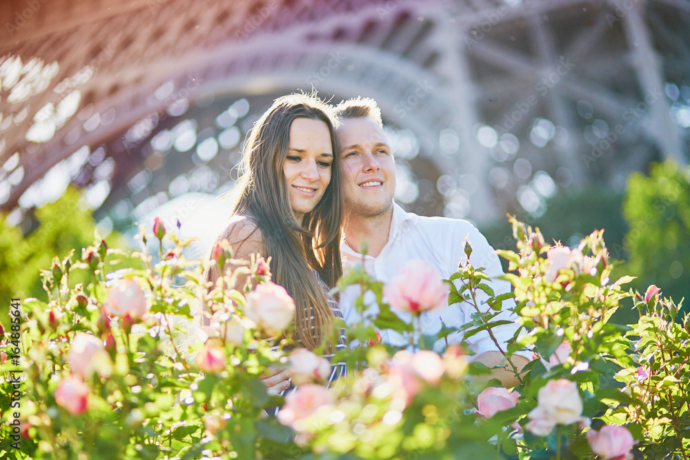 Romantic couple near the Eiffel tower in Paris Romantic couple near the Eiffel tower in Paris