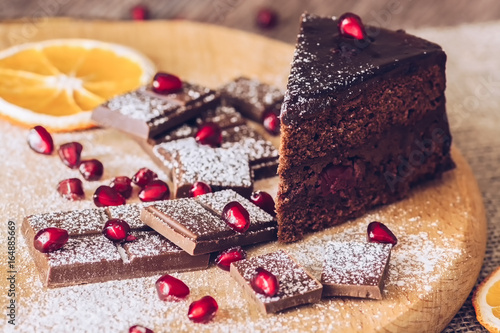 Chocolate Torg with dark chocolate decorated with dried pomegranate and orange. photo