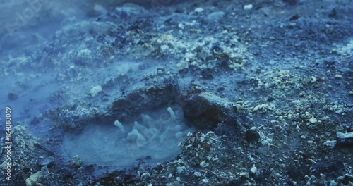 Close up, boiling mud pit in slow motion