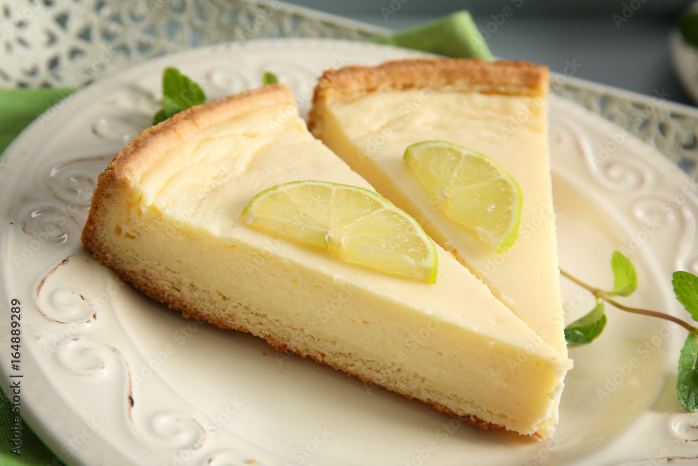 Plate with delicious slices of cheesecake, closeup