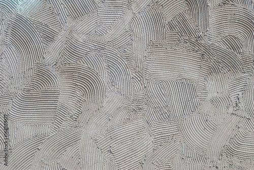 grey decorative relief plaster on wall, background texture