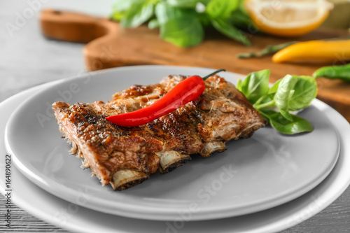 Delicious grilled spare ribs with chili on plate