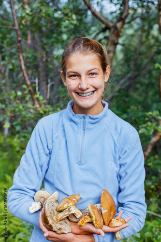 Girl with wild mushroom found in the forest