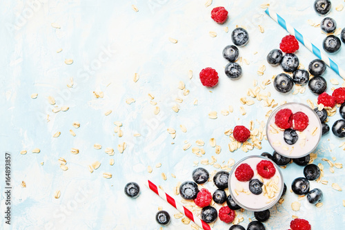 Milkshake with oatmeal, blueberries and raspberries, top view