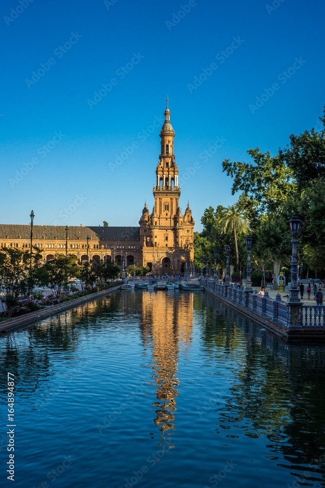 The tower in plaza de espana with reflection in water in Seville, Spain, Europe