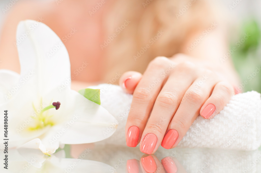 Manicure concept. Beautiful woman's hand with perfect manicure at  beauty salon.